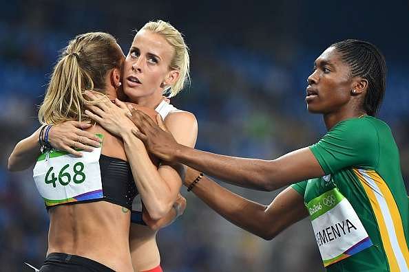 Canada's Melissa Bishop (L) hugs Britain's Lynsey Sharp (C) next to gold medallist South Africa's Caster Semenya after the Women's 800m Final